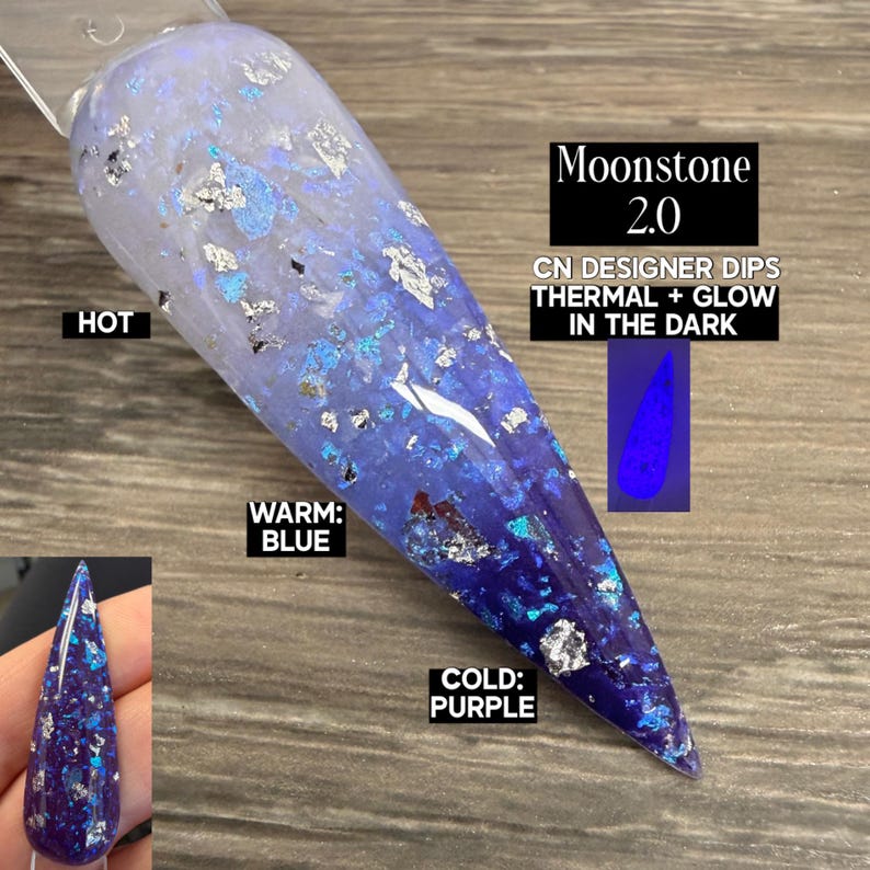 May include: A nail swatch with a color-changing design. The nail transitions from a light blue to a deep purple, with silver and blue glitter accents. The text on the image reads "Moonstone 2.0" and "Thermal + Glow in the Dark".