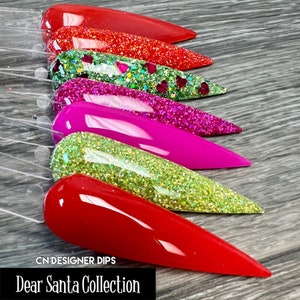 May include: A set of six nail dip powders in red, green, and pink shades with glitter. The set is labeled "Dear Santa Collection" and "CN Designer Dips".