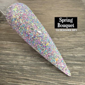 May include: A white ceramic mug with a black handle and the text "But First, Coffee" in a black, bold font. The mug is sitting on a wooden surface. The mug is approximately 4 inches tall.