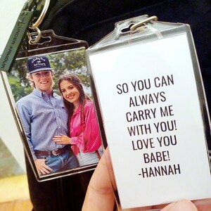 May include: A clear plastic keychain with a photo of a couple and a message that reads "So you can always carry me with you! Love you babe! -Hannah".