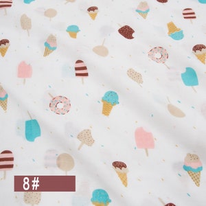 May include: White fabric with a repeating pattern of ice cream cones, popsicles, and doughnuts. The fabric has a light blue, pink, brown, and beige colour scheme. The text "8#" is printed in brown at the bottom of the image.