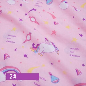 May include: Pink fabric with a repeating pattern of unicorns, rainbows, stars, and diamonds. The text "Unicorn and Rainbow" is repeated throughout the fabric. The number "2#" is written in purple at the bottom of the image.