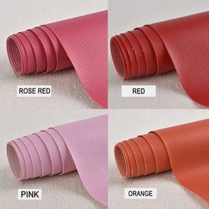 May include: Four rolls of faux leather in different colors: rose red, red, pink, and orange. The leather has a textured surface.