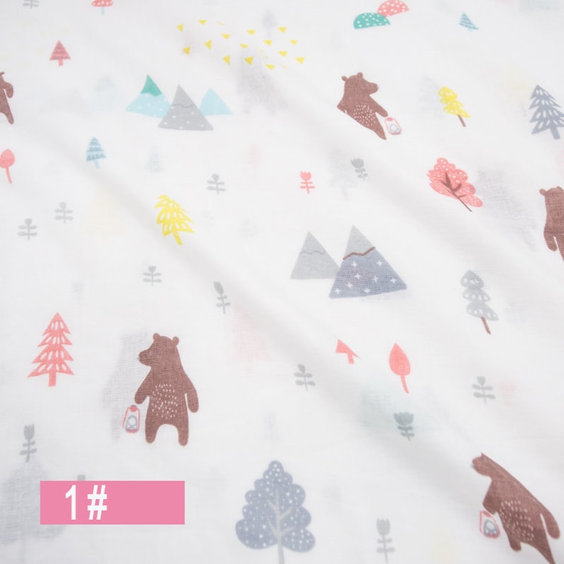 May include: White fabric with a repeating pattern of brown bears, trees, mountains, and stars. The fabric has a light pink label with the number "1#" on it.