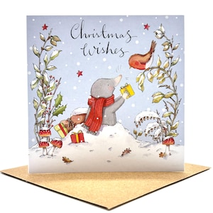 May include: A square greeting card featuring a light blue winter scene with the text Christmas Wishes. A grey mole wearing a red scarf sits in the snow holding a yellow gift, facing a small robin perched on a branch. Red mushrooms and gifts are visible.