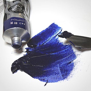 May include: A tube of blue paint labeled "443 Ultramarine 蓝  Professional for Artists" with a blue paint swatch on a white surface.