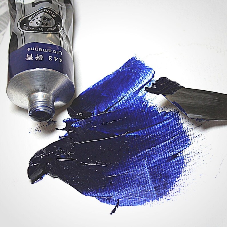 May include: A tube of blue paint labeled "443 Ultramarine 蓝  Professional for Artists" with a blue paint swatch on a white surface.