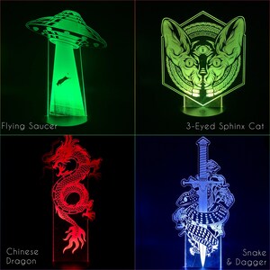 May include: Four different night light designs: a green flying saucer, a green three-eyed sphinx cat, a red Chinese dragon, and a blue snake wrapped around a dagger.