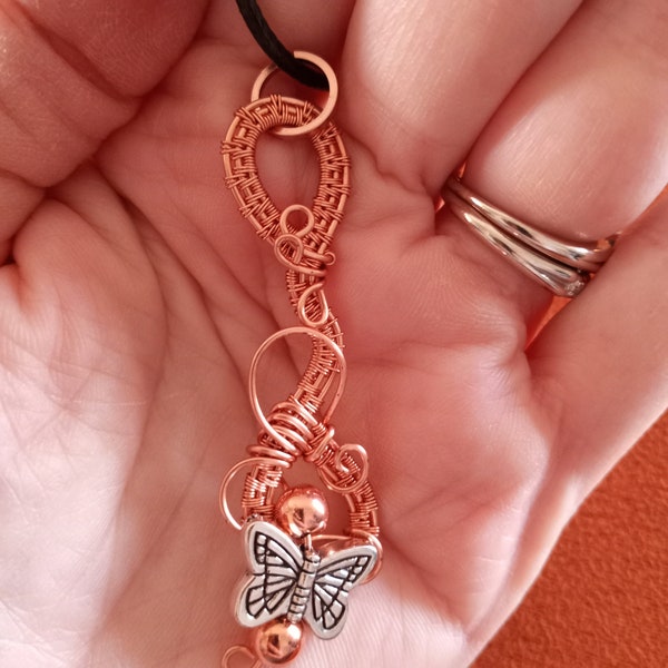 Beautiful and unique hand woven copper wire pendant adorned with alloy metal butterfly charm (supplied with cord necklace)