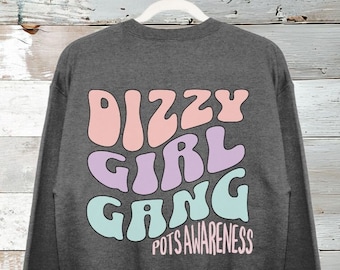 May include: Two gray sweatshirts. One has a pink skeleton hand graphic on the front. The other has "Dizzy Girl Gang" in pastel colors on the back with the text "POTS Awareness" below.