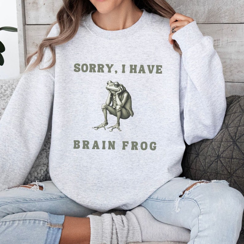 May include: Gray sweatshirt with the text "Sorry, I have Brain Frog" and a cartoon frog with a thoughtful expression.
