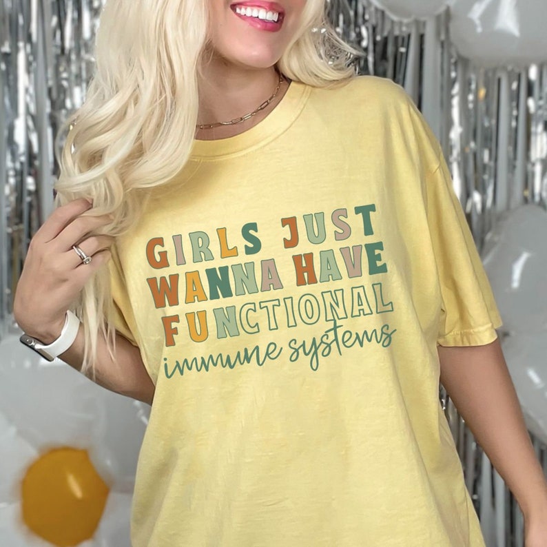 May include: Yellow t-shirt with the text "Girls Just Wanna Have Functional Immune Systems" in a rainbow of colors.