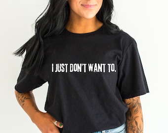 May include: Black t-shirt with the text "I JUST DON'T WANT TO." in white lettering.