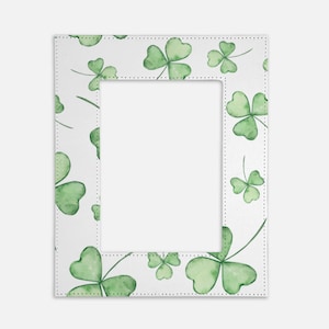 May include: White picture frame with a green shamrock pattern border. The frame has a white background and a white mat.