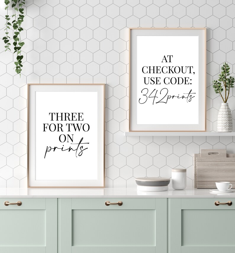 May include: Two framed prints with white backgrounds and black text. The print on the left says "Three for two on prints". The print on the right says "At checkout, use code: 342prints".
