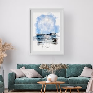 May include: A framed wall art print featuring a watercolor landscape of a blue sky, dark hills, and a reflective body of water. The artwork includes the text "Our happy place" in a black script font centered below the painted scene.