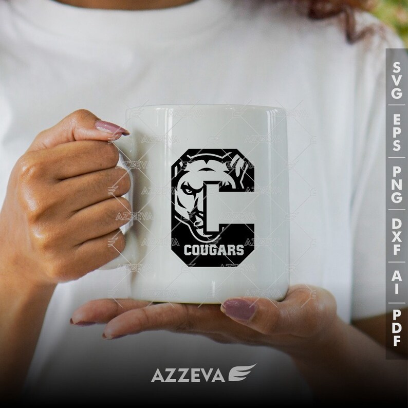 May include: White ceramic mug with a black graphic of a cougar's head inside a letter C with the word "Cougar" below it.