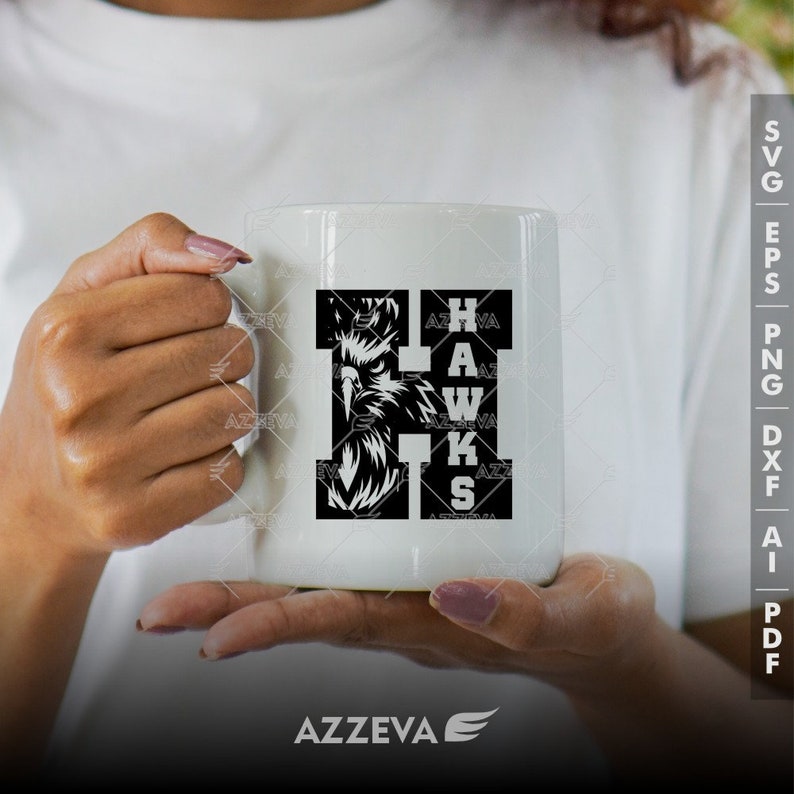 May include: White ceramic mug with a black and white graphic of a hawk's head and the word "HAWKS" spelled out in a unique font.