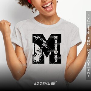 May include: A white t-shirt with a black graphic of a stylized letter "M" with a Native American warrior's head inside the letter. The text "MOHAWKS" is vertically aligned to the right of the letter "M".