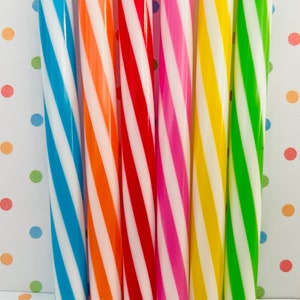 May include: Six striped straws in various colors, including blue, orange, red, pink, yellow, and green. The straws are all white and have a spiral pattern.