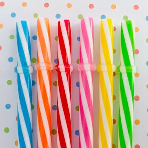 May include: Six striped drinking straws in different colors: blue, orange, red, pink, yellow, and green. The straws are all the same size and have a white stripe.