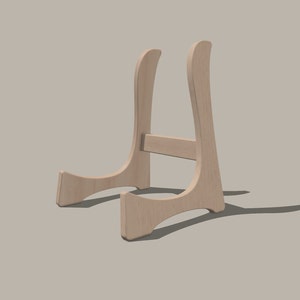 May include: A wooden display stand with a curved design. The stand is made of light brown wood and has a simple, elegant look.