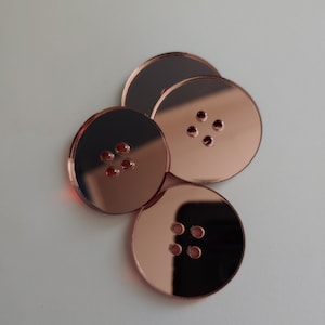 May include: Four rose gold mirror-like round buttons with five holes each.