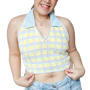 May include: A blue and yellow plaid crochet halter top with a blue collar. The top is cropped and has a V-neck.