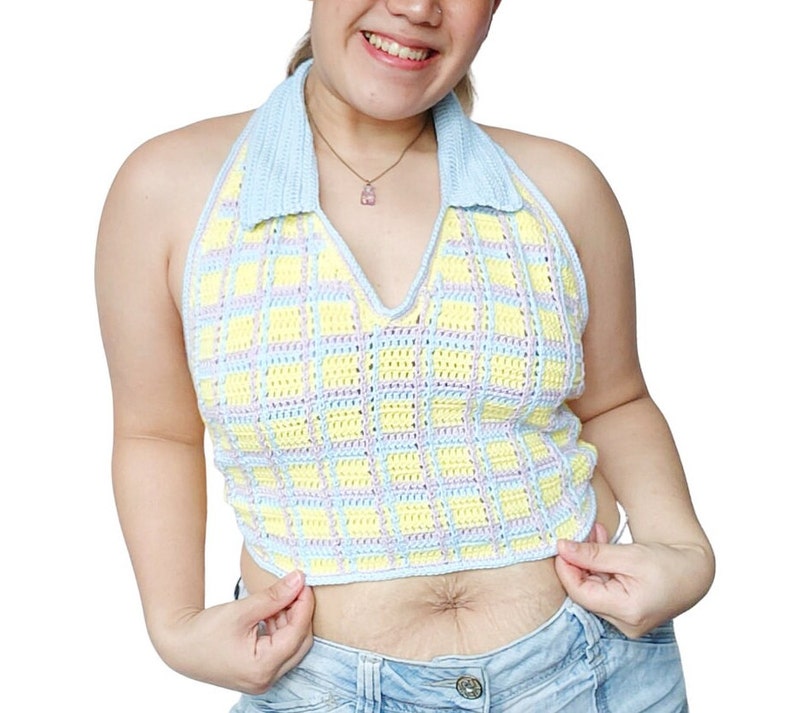 May include: A blue and yellow plaid crochet halter top with a blue collar. The top is cropped and has a V-neck.