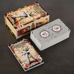 May include: A deck of cards and a box set with the words "Fantasy Night Theaters" on the box and card deck. The box and card deck feature illustrations of a couple dancing and a clock design. The box is beige with a colorful illustration.