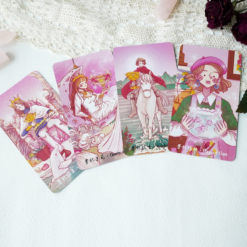 May include: Four tarot cards with pink backgrounds and illustrations of people and animals. The cards are labeled "Queen of Cups", "Knight of Cups", "Page of Cups", and "King of Cups".
