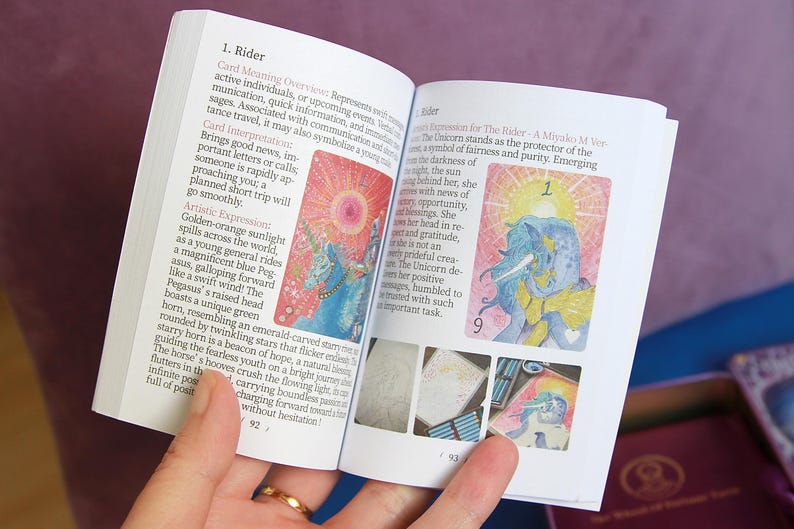 May include: An open guidebook with white pages featuring black printed text and colourful illustrations of a unicorn and a pegasus. The left page is titled 1. Rider and includes descriptive paragraphs. The right page shows a unicorn illustration.