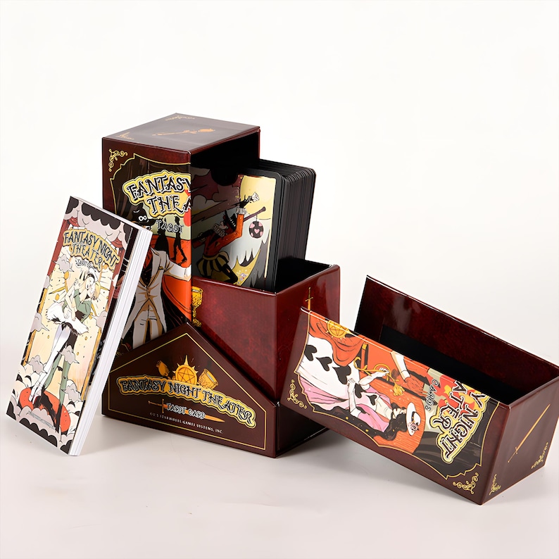 May include: A Fantasy Night Theater card game set. The set includes a box, a deck of cards, and a booklet. The box is burgundy with gold accents and the game title. The cards and booklet feature illustrations of characters in a fantasy setting.