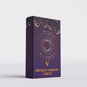 May include: A rectangular deck box for the Broken Mirror Tarot with a deep purple background. The front features a gold foil illustration of a crescent moon surrounded by radiating lines and stars, with clouds at the top and the Roman numeral V.
