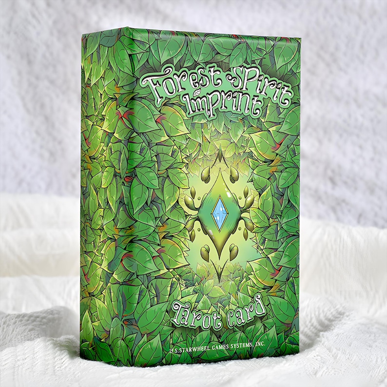 May include: A tarot card deck box with a green leafy design. The box features the text "Forest Spirit Imprint" and "Tarot card" in a stylized font. A central design element includes a diamond shape with a light blue center.