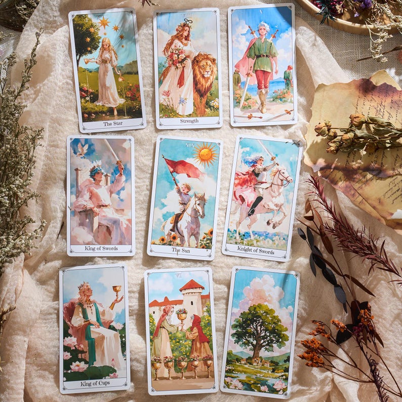 May include: A collection of tarot cards featuring colorful illustrations. The cards depict figures in various scenes, including a woman with a lion, a figure with a sword, and a person holding a cup. The cards have white borders and text labels.