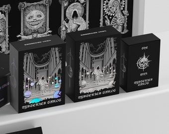 Könnte beinhalten: Drei schwarze Boxen mit dem Text "The Mini Mysteries Tarot" auf der Vorderseite. Die Boxen stehen auf einer weißen Oberfläche. Die Boxen sind alle unterschiedlich groß. Die größte Box hat ein Design mit einer Figur in einer Robe, die in einer Kathedrale steht. Die mittlere Box hat ein Design mit einer Figur in einer Robe, die in einer Kathedrale steht. Die kleinste Box hat ein Design mit einem Schädel mit einem Kompass drumherum.