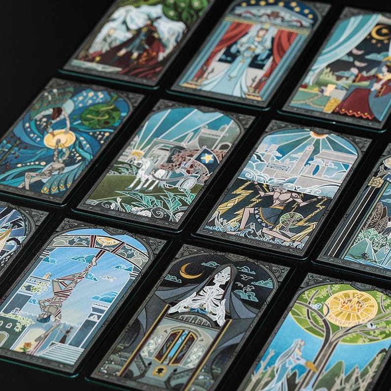 May include: A collection of rectangular tarot cards arranged in a grid, each featuring detailed, colourful illustrations with dark borders. The cards display various scenes including figures, celestial elements, architectural structures, and skeletons.