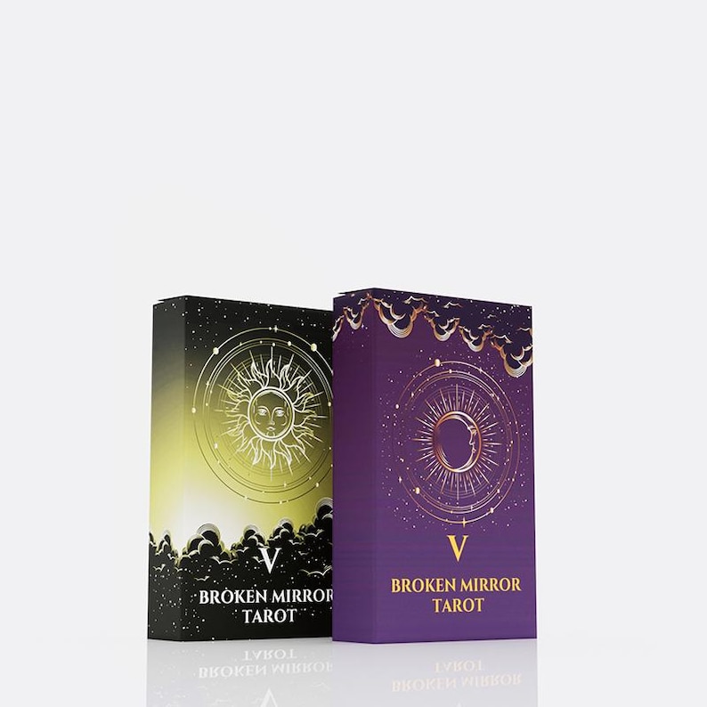 May include: Two rectangular tarot card decks titled Broken Mirror Tarot. The left deck features a yellow-to-black gradient with a sun illustration. The right deck is purple with a moon illustration. Both boxes display the Roman numeral V and text.