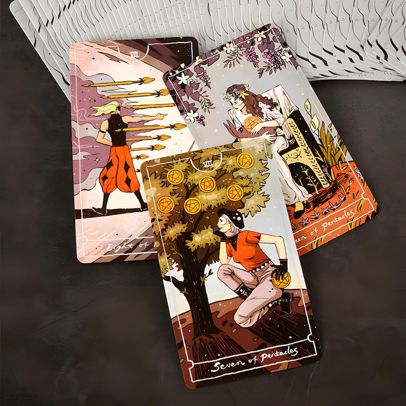 May include: Three tarot cards with colorful illustrations. The cards feature images of figures, trees, and symbols. The cards are labeled "Eight of Wands" and "Seven of Pentacles". The cards are part of a deck.