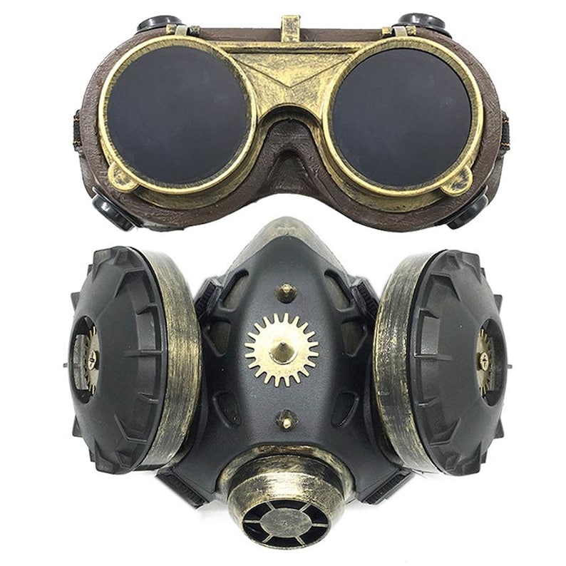 May include: A steampunk-style gas mask with a black and gold design. The mask has two large round filters on the sides and a smaller filter in the front. The mask is attached to a pair of goggles with round lenses.