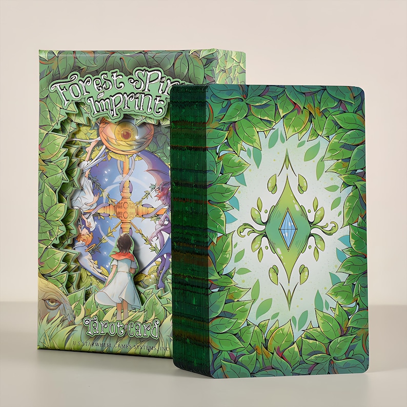 May include: A tarot card deck and box set. The box features the text "Forest Spirit Imprint" and a cutout design with illustrations of figures. The card backs have a green leaf design. The deck is green-edged.