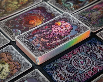 May include: A deck of rectangular playing cards with holographic edges, featuring intricate, colorful illustrations of grotesque creatures and occult symbols. The top card displays a multi-eyed, textured entity with the text Eihort printed below it.