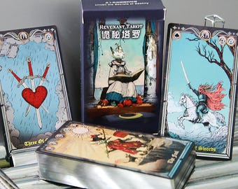 May include: A deck of Revenant Tarot cards with a box. The box has the title "Revenant Tarot" and Chinese characters. Several cards are visible, including "Three of Swords" and "The Fool". The cards feature illustrations with a fantasy theme.