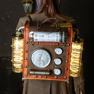May include: A brown leather steampunk backpack with brass accents and two glass tubes with glowing lights. The backpack has a round gauge with the word "BAOYI" and a needle pointing to the number 10. There are also three smaller gauges on the front.