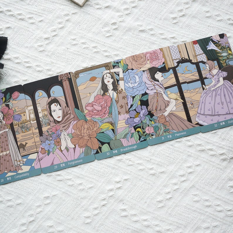 May include: A set of tarot cards with illustrations of women in various settings. The cards are numbered 28, 29, 30, 31, and 32. The card titles are Compatibility, Forgiveness, Breakthrough, Plainness, and Dust.