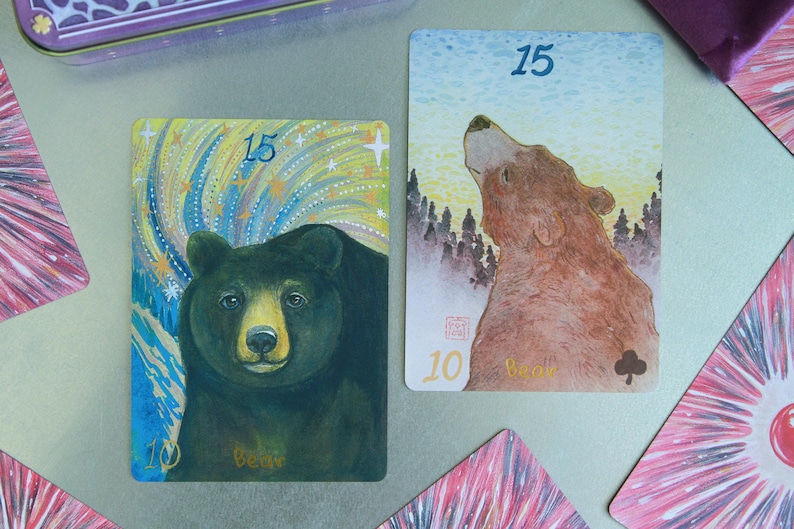May include: Two rectangular playing cards featuring bear illustrations. The left card shows a black bear against a starry sky with the number 15 and the word bear. The right card shows a brown bear looking upward at a forest with the number 15.