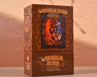 May include: Two-piece brown box set with the text "Whimsical Realm of Oddities". The top box features a colorful illustration of a skeleton and other imagery. The bottom box has the text "78 cards with book".
