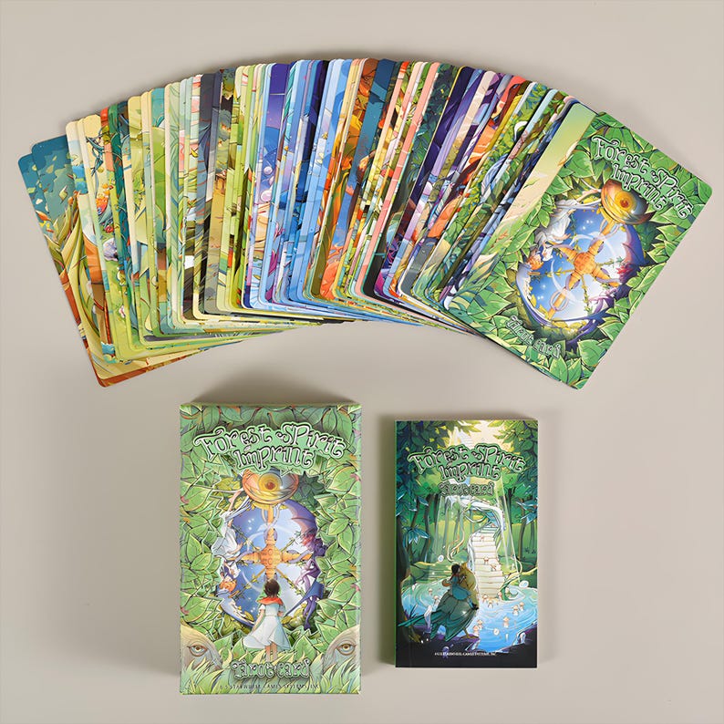 May include: A deck of "Forest Sprite Impirits" tarot cards fanned out, with two boxes. The cards feature colorful fantasy art. The boxes and card backs have a green leafy design with the title "Forest Sprite Impirits".