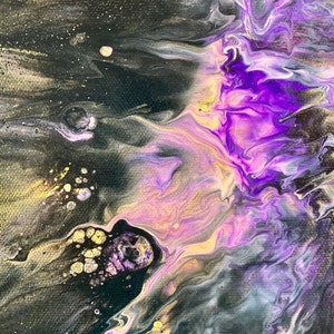 May include: Abstract painting with swirling purple, gold, and black paint. The colors blend together to create a galaxy-like effect.